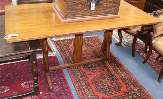An early 20th century rectangular oak refectory dining table on carved end supports W.145cm